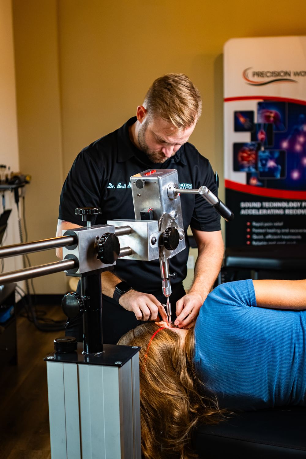 Dr. Brett Berner using a precision Orthospinology instrument to perform a gentle, low-force upper cervical correction at Foundation Chiropractic
