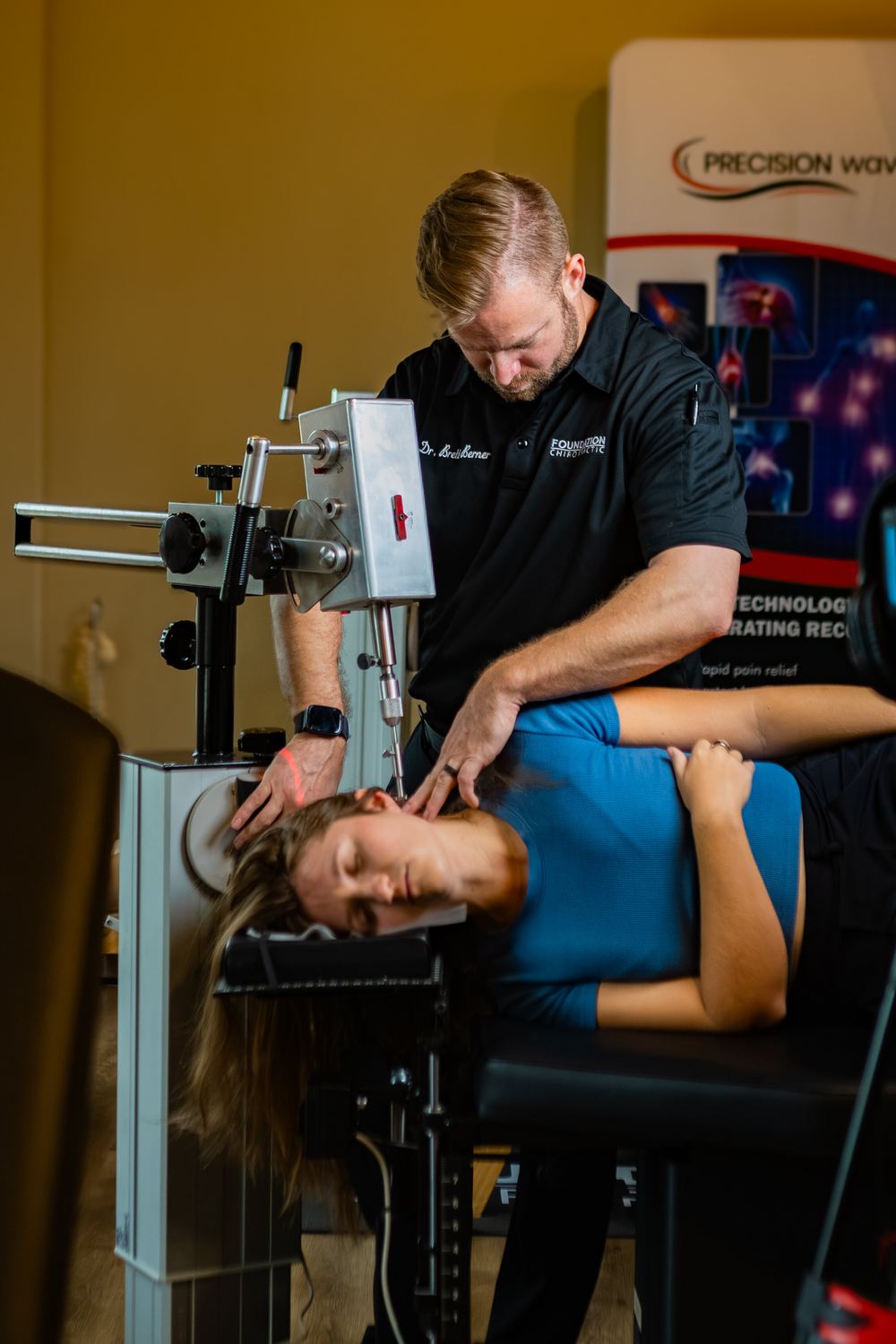Dr. Brett Berner carefully positioning a patient for a precise upper cervical adjustment, no twisting or cracking involved